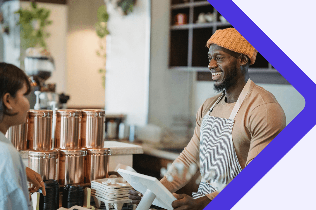 Man serving a customer in a coffee shop