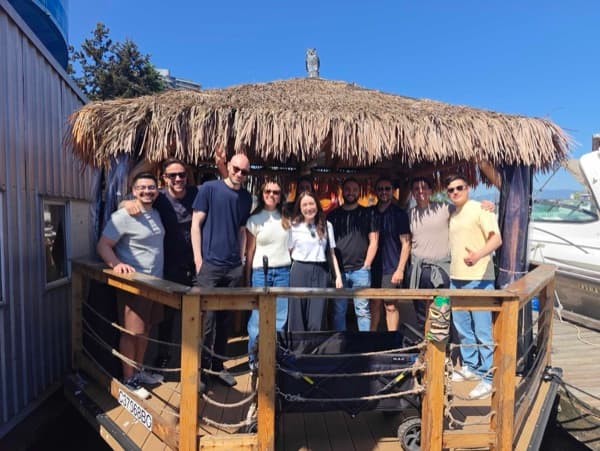 Durable teammates crowded onto the deck of a tiki boat